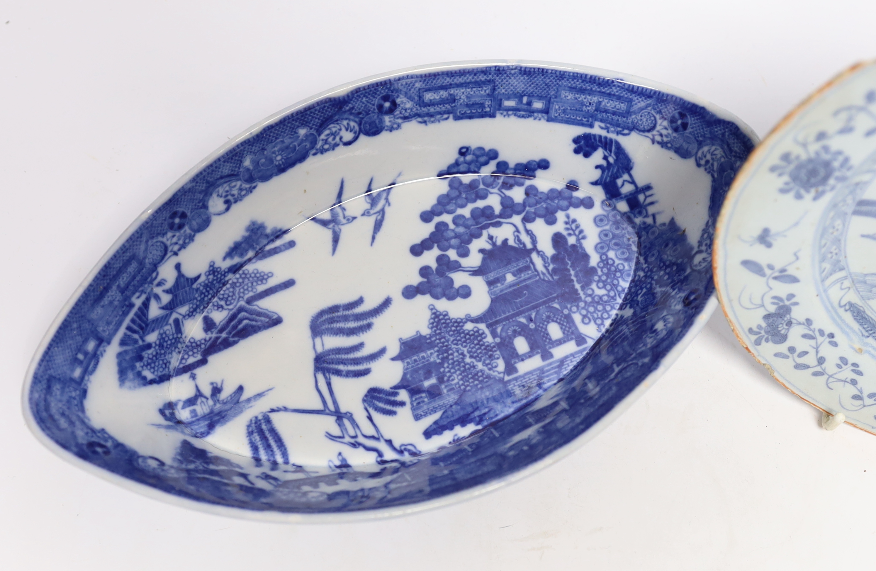 An 18th century delftware plate and blue and white pearlware plate, largest 28cm wide